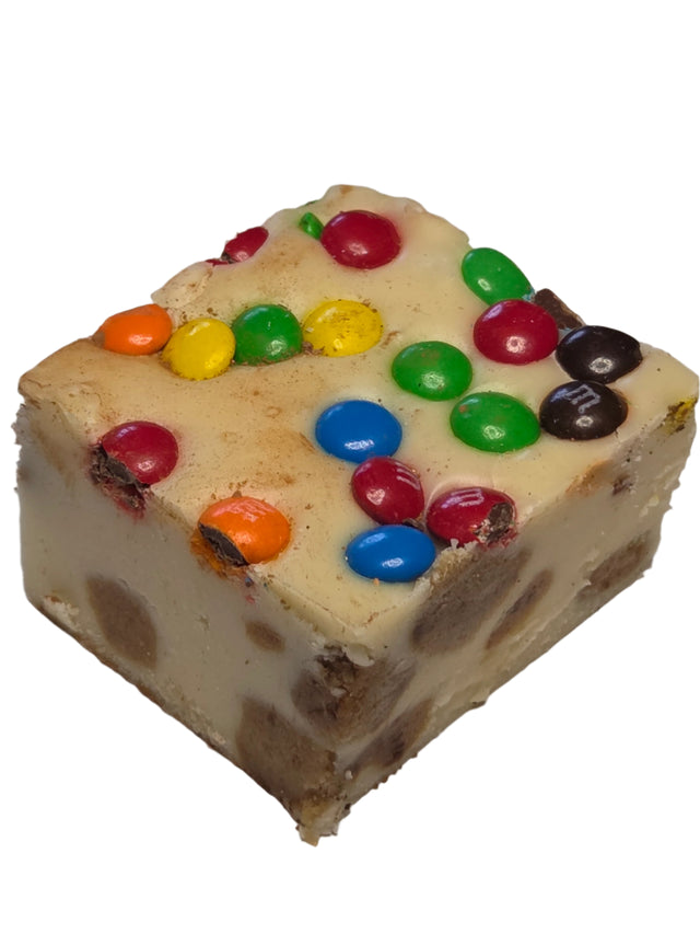 Square creamy cookie-filled fudge topped with colorful M&M candies