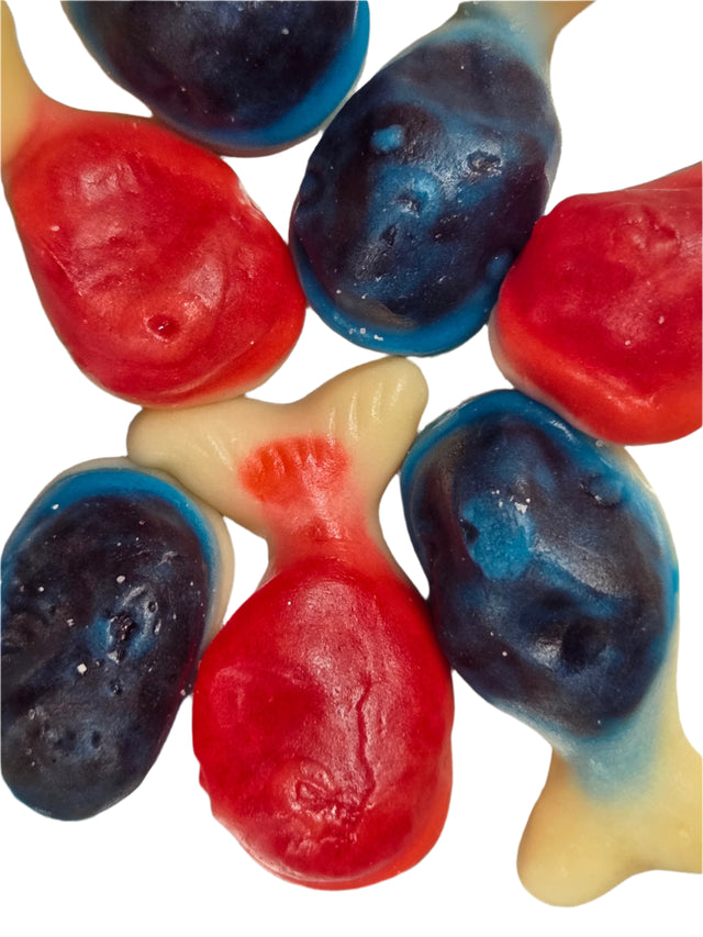 Colorful Whales Gummies: red, blue, beige fish candies with glossy gelatin texture