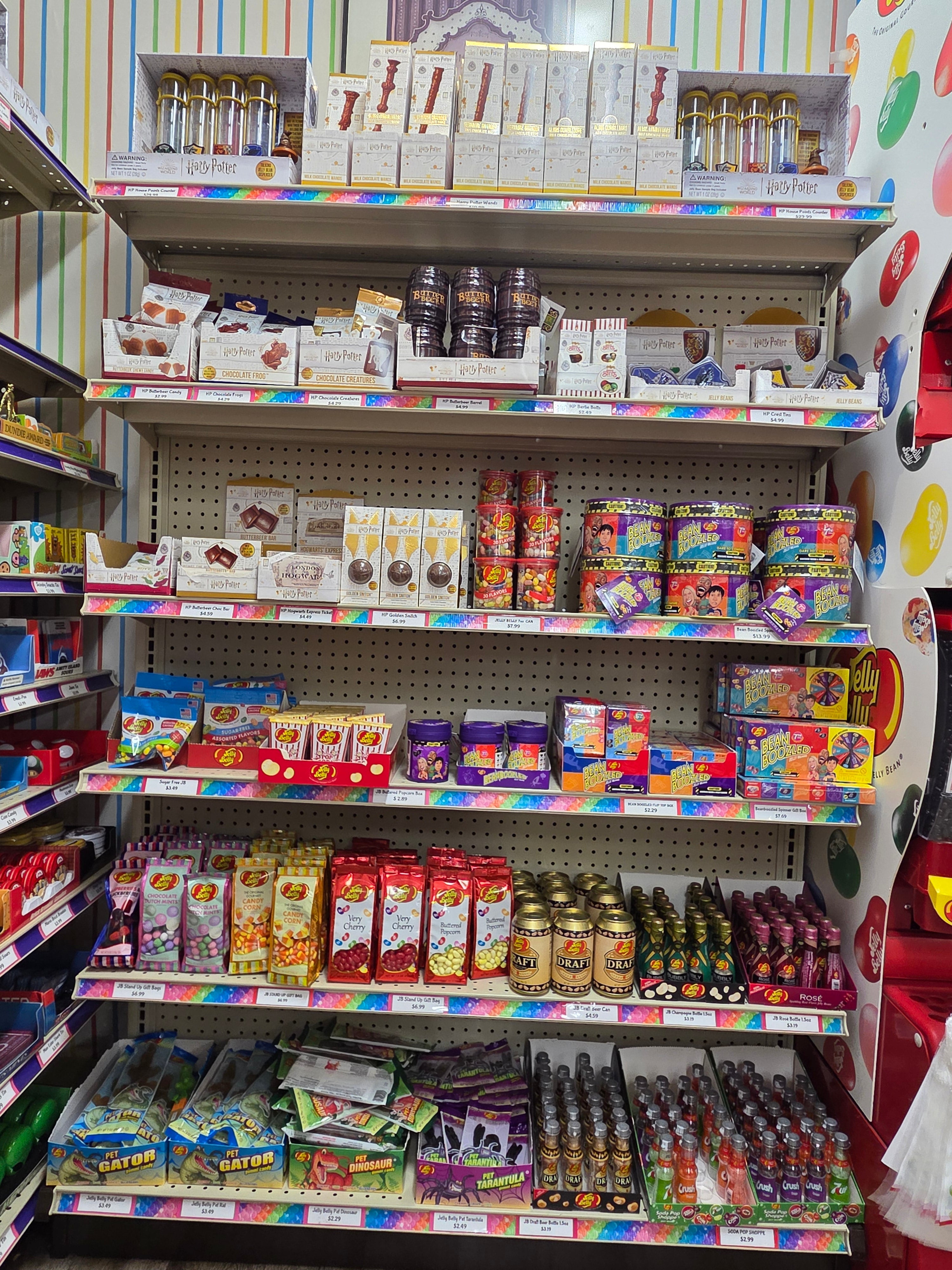Rainbow-striped shelf of colorful Harry Potter candies in Jelly Belly pack
