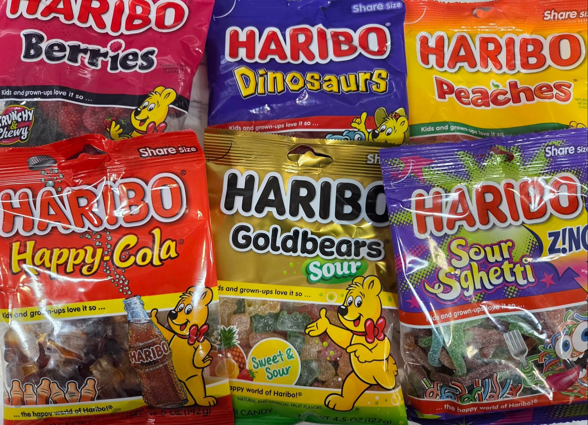 Colorful Haribo and Air Heads candy bags on store shelf