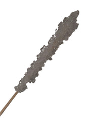 Clear rock candy stick on wooden stick with jagged crystalline formations