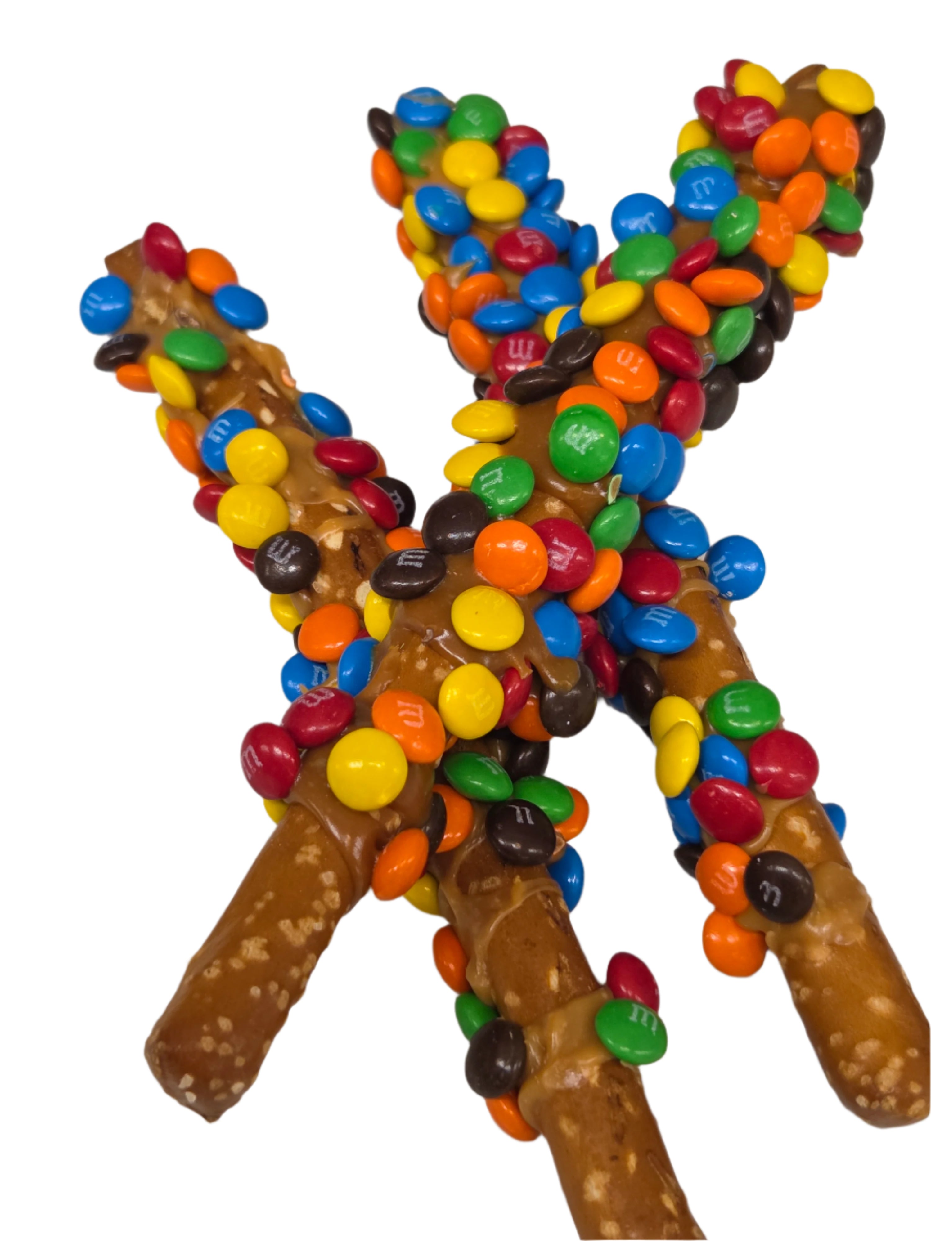 Colorful M&M’s coated caramel pretzel rods in cross shape