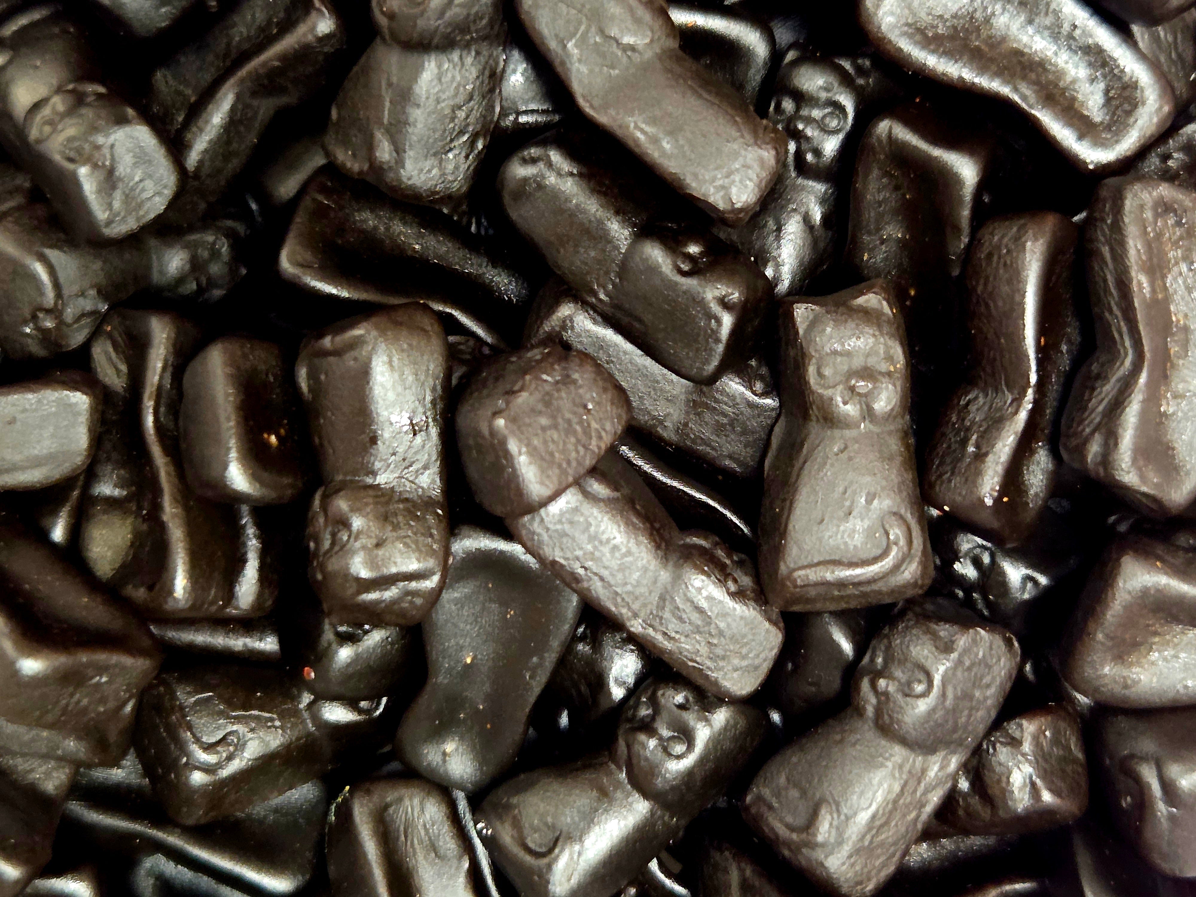 Glossy dark chocolate licorice cats and animal gummy candies