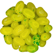 Pile of bright yellow glossy Juicy Pear Jelly Belly jelly beans with green speckles
