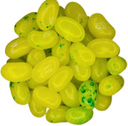 Pile of bright yellow glossy Jelly Belly Mango Jelly Beans with green speckles