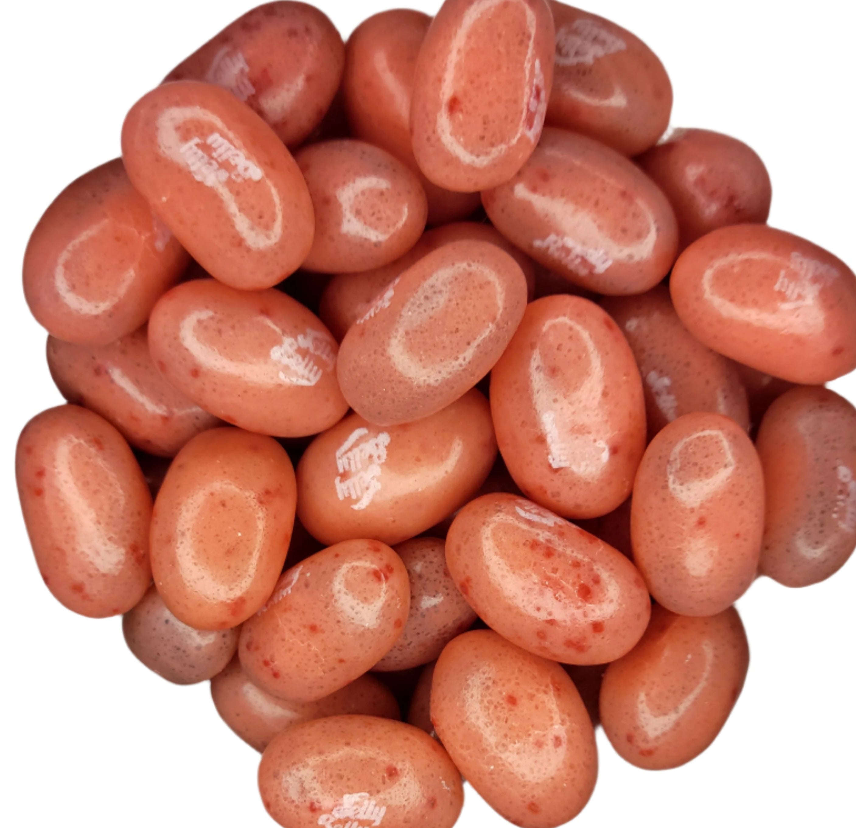 Pile of glossy peach Jelly Belly Strawberry Daiquiri jelly beans with red speckles
