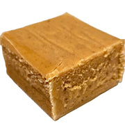 Square golden-brown pumpkin fudge with smooth textured surface and specks