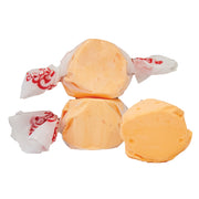 Orange Taffy POG candies wrapped in white paper with red branding