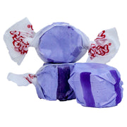 Purple wrapped Taffy Grape candies with red logo on white paper
