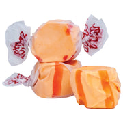 Taffy Orange: orange and red striped taffy in white paper with red logo