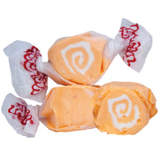 Orange and white swirled Taffy Orange Cream candies in clear cellophane