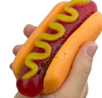 Giant gummy hotdog in vibrant orange and red with mustard squiggles