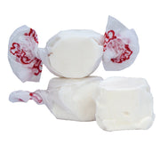 White Taffy Vanilla candies wrapped in translucent paper with red branding