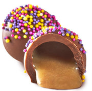 Milk Chocolate Birthday Cake Truffle: glossy caramel egg with colorful sprinkles