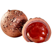 Rich dark chocolate sphere cracking to reveal glossy red filling in Milk Chocolate Tiramisu