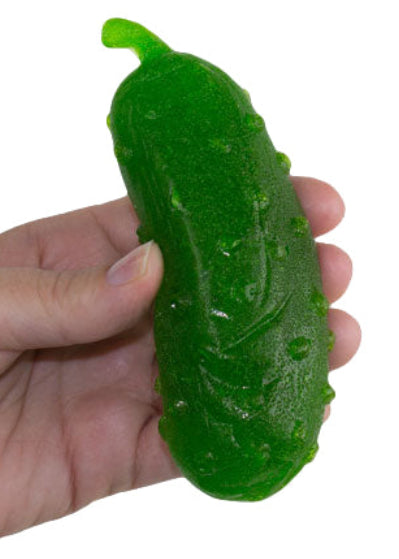 Hand holding vibrant green glossy Giant Gummy Pickle stress reliever