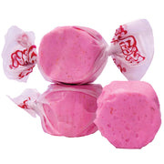Pink strawberry taffy in clear cellophane with red Taffy Xtreme Hot branding