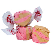 Taffy Maple Bacon pink and peanut butter swirl taffy in white paper with red florals