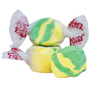 Taffy Pineapple: Green and yellow swirled taffy in white paper with red branding