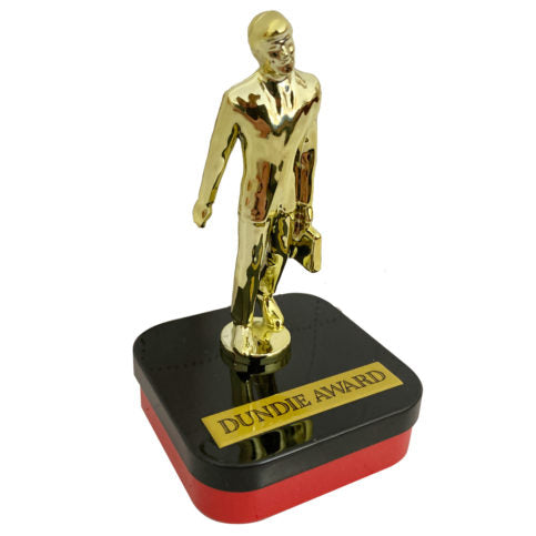 Golden Dundie Award figurine in suit with briefcase on red black base, in candy tin