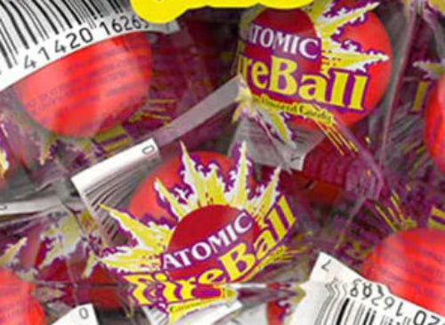 Red Atomic Fireballs cinnamon candy in shiny colorful wrappers