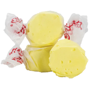 Yellow Taffy Butter candies wrapped in white paper with red dragon designs