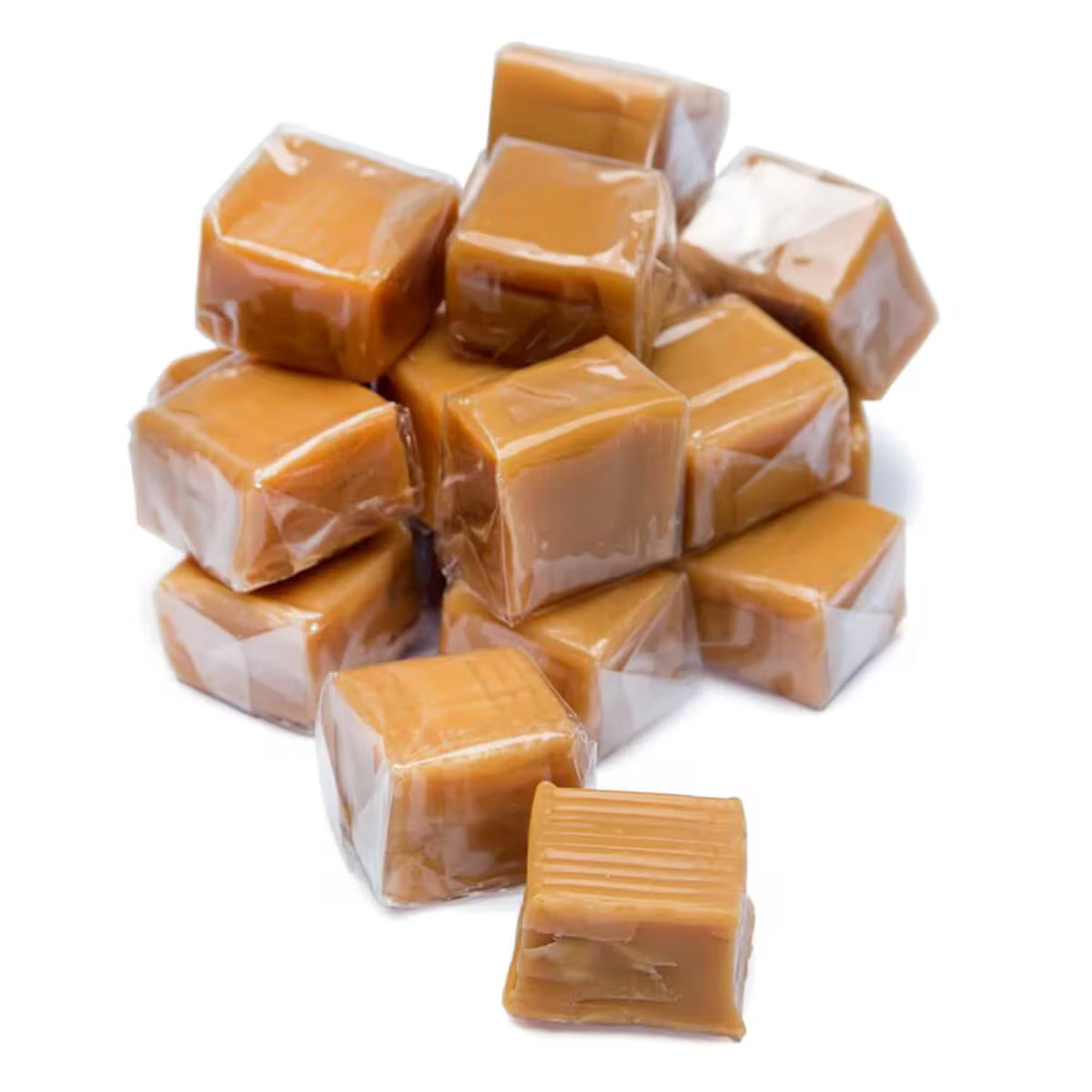 Pile of glossy amber vanilla caramels in clear plastic wraps, bulk wrapped