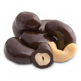 Dark chocolate-covered cashews, one halved to show creamy interior