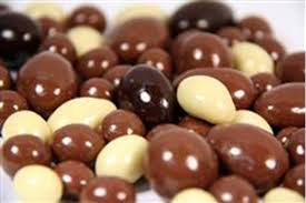 4 Piece Panned Chocolate Sampler with glossy oval candies in brown and white