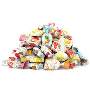 Colorful pile of fruit-filled wrapped hard candies with strawberry, pineapple, and cherry designs