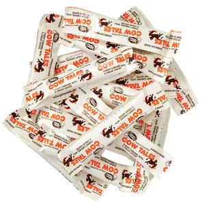 Mini Cow Tales Bulk: white and orange candy sticks with red cow logo