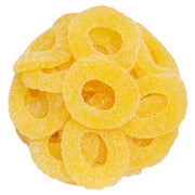 Pile of bright yellow sour pineapple rings gummy candy