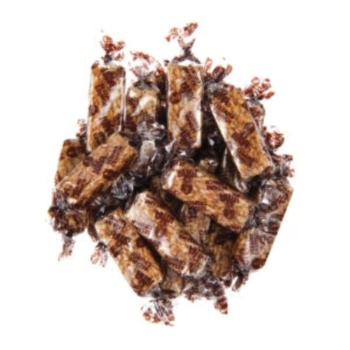 Sesame Crunch pile of glossy chocolate-covered caramel candies with speckles