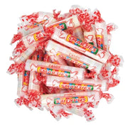 Pile of individually wrapped red and white Smarties candy rolls