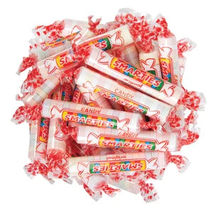 Pile of individually wrapped red and white Smarties candy rolls