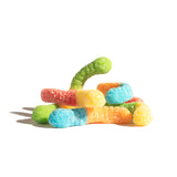 Pile of sour mini neon inch worms in vibrant red, green, blue, orange hues
