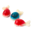 Three translucent candy-colored Whales Gummies fish with white tails and red or blue bodies